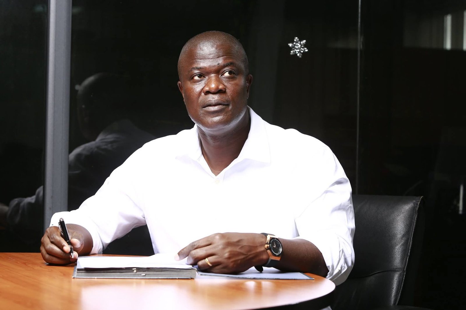 Eloge Beonao reviewing documents during a working session